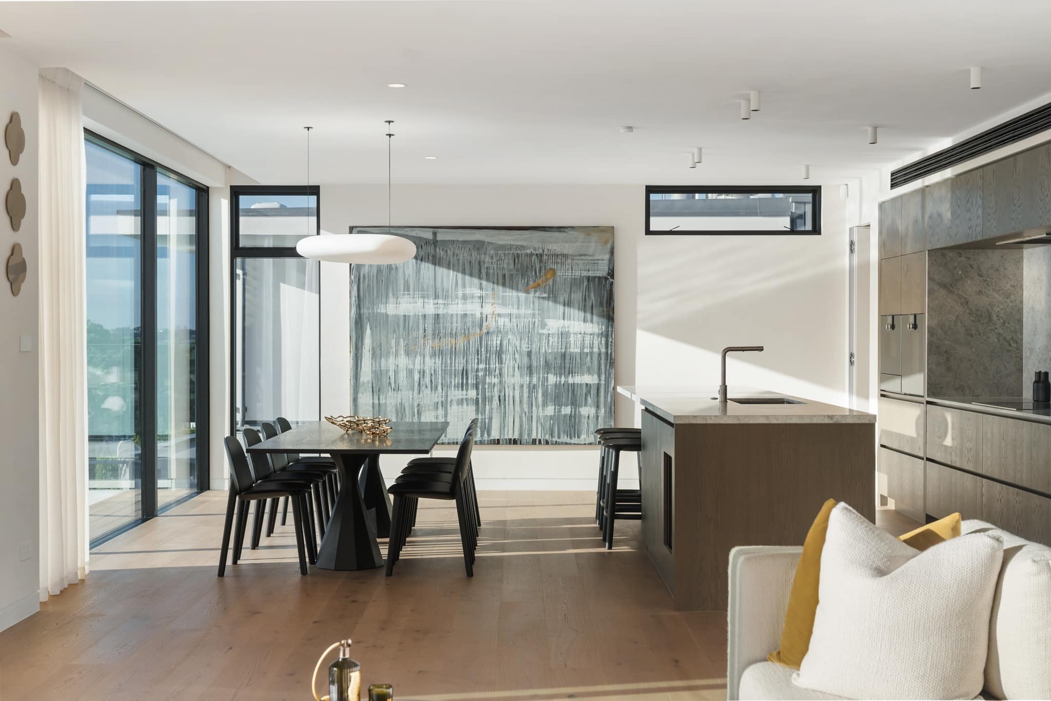 A bright dining and kitchen space with a lacquered engineered oak floor.
